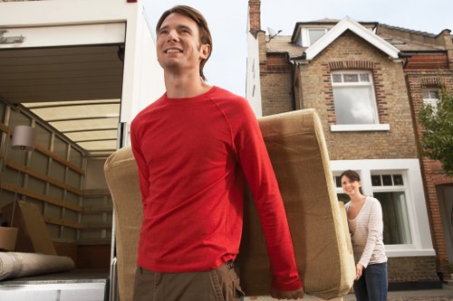 Movers handling items near a busy South Kensington property