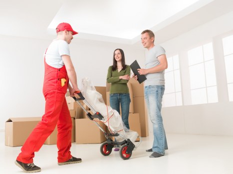 Local movers carrying items through a South Kensington property entrance