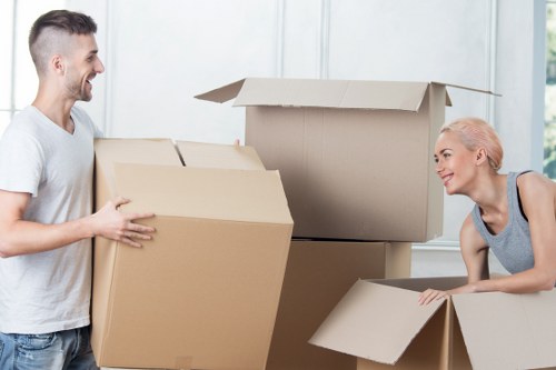 Professional moving crew managing household items with care