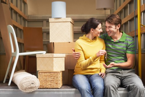 Local removals team handling boxes and furniture near South Kensington flats