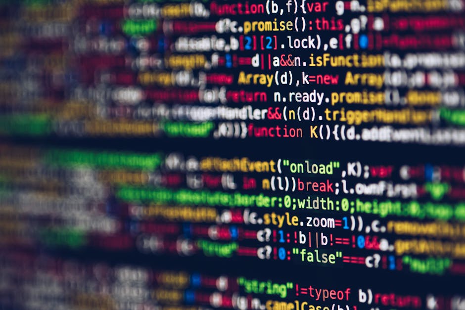 A close-up photograph showing multicoloured lines of computer code displayed on a computer screen, including syntax elements such as functions, variables, and operators in various colours like red, gr